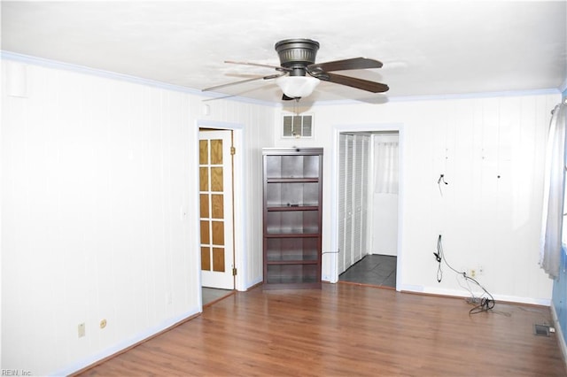 empty room featuring ornamental molding, dark hardwood / wood-style floors, and ceiling fan