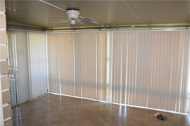 unfurnished sunroom with ceiling fan