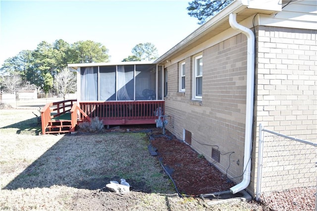 view of side of home with a deck and a sunroom