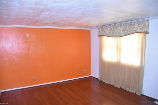 spare room featuring hardwood / wood-style flooring and ornamental molding