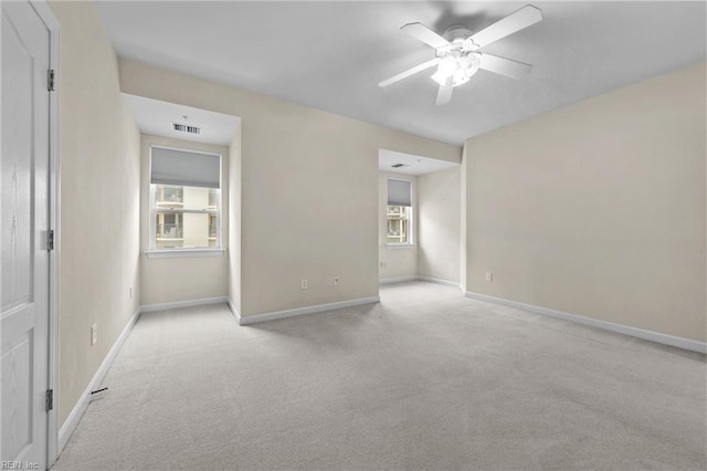 unfurnished room with light carpet and ceiling fan