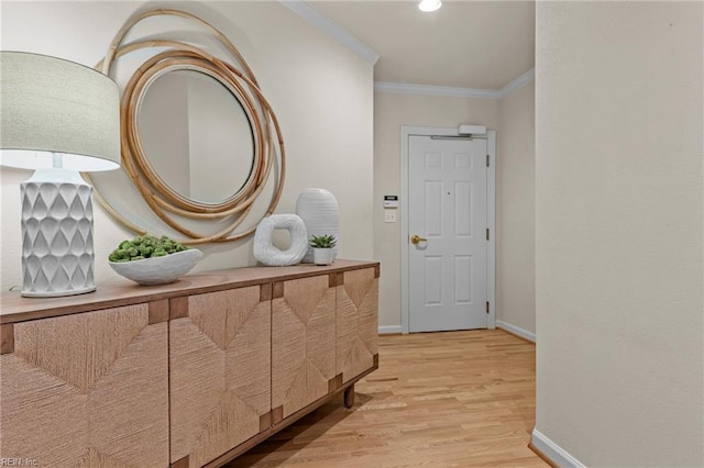 corridor featuring crown molding and light hardwood / wood-style flooring