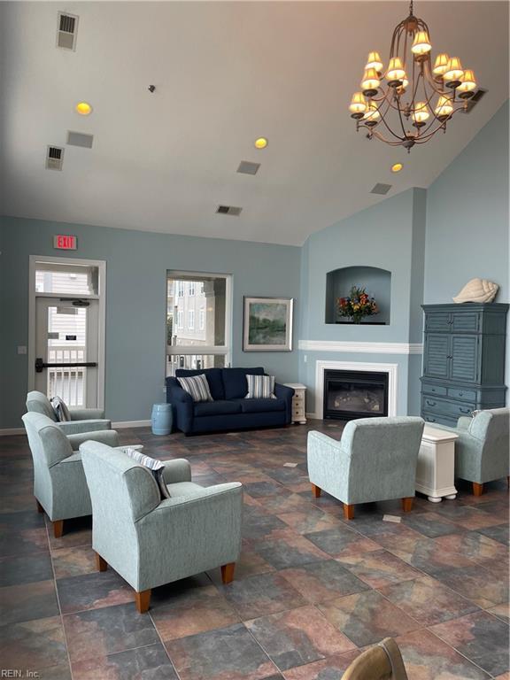 living room with a chandelier and high vaulted ceiling