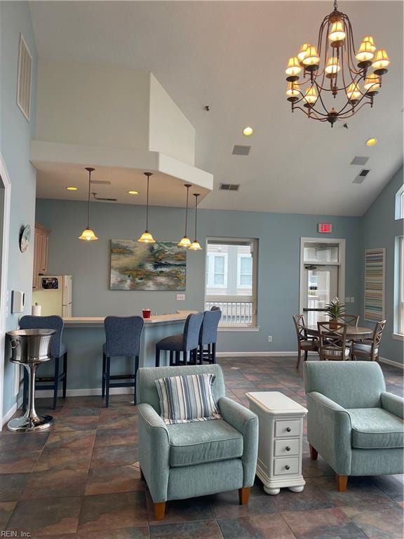 living room with an inviting chandelier and high vaulted ceiling