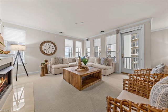 living room featuring ornamental molding, light carpet, and a fireplace