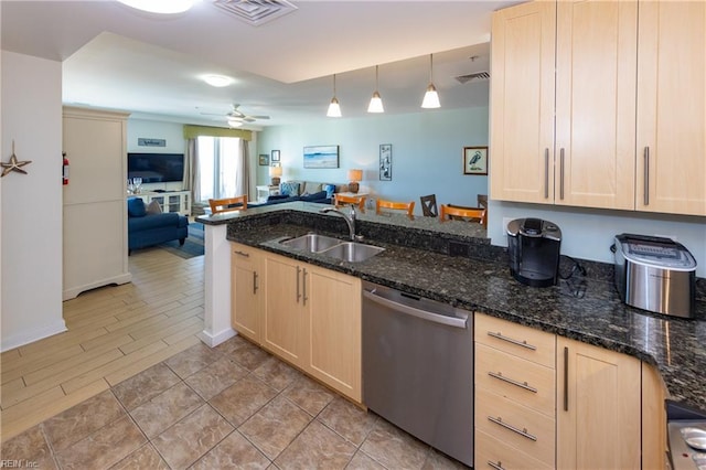 kitchen with sink, hanging light fixtures, stainless steel dishwasher, kitchen peninsula, and light brown cabinets