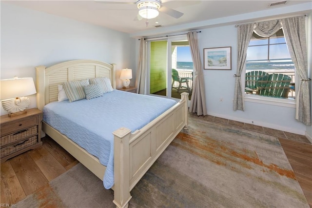 bedroom featuring ceiling fan, access to exterior, and hardwood / wood-style floors