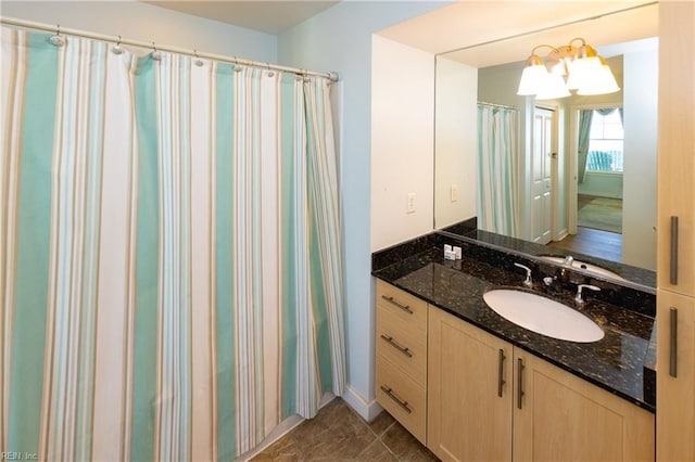 bathroom featuring vanity and a chandelier