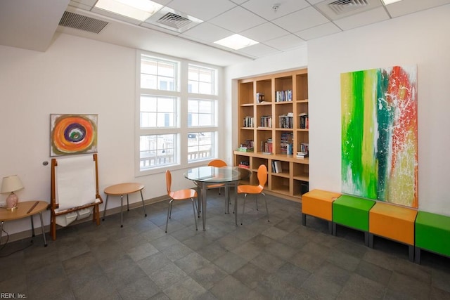 recreation room featuring a paneled ceiling