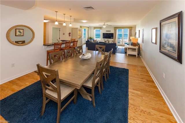 dining area featuring ceiling fan and light hardwood / wood-style flooring