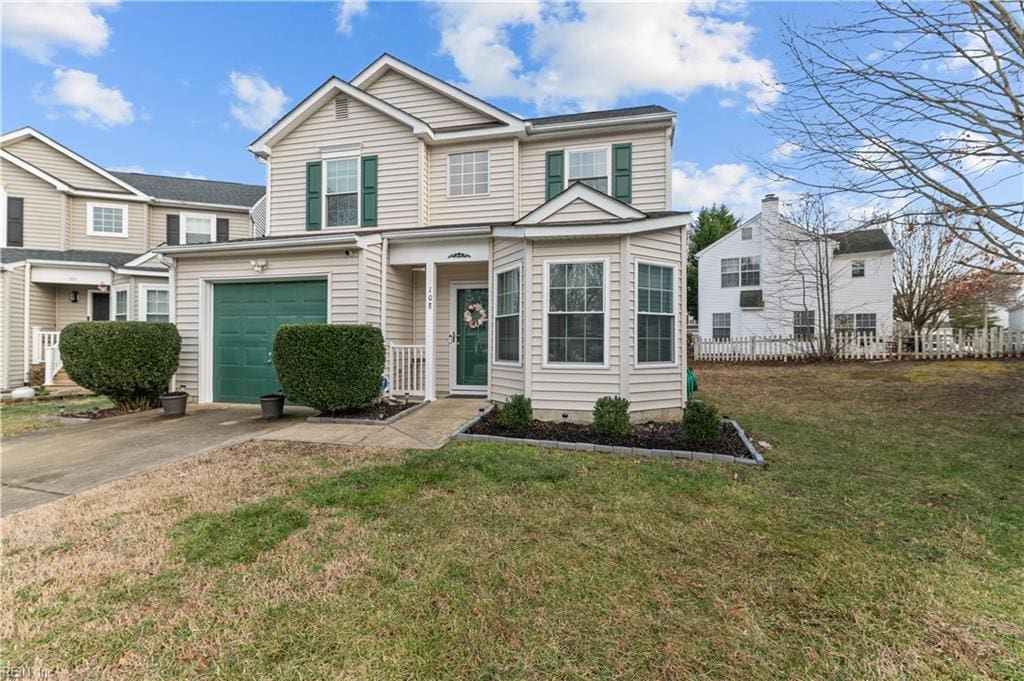 view of front of home featuring a garage and a front lawn