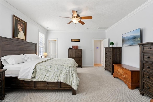 carpeted bedroom with ceiling fan, crown molding, and a textured ceiling