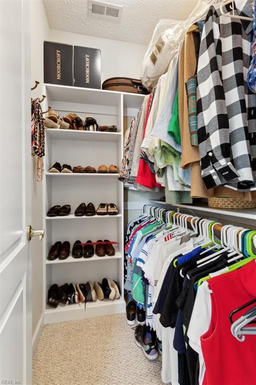 walk in closet featuring carpet floors