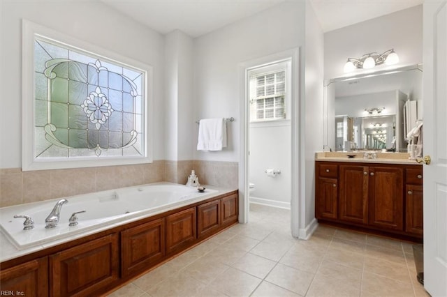 bathroom with vanity, tile patterned flooring, toilet, and a bathing tub