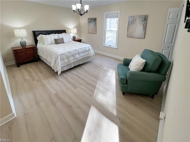 bedroom featuring a notable chandelier and light hardwood / wood-style floors