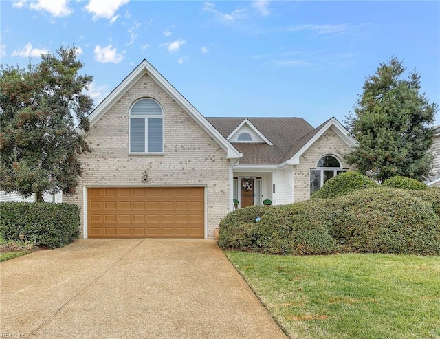 view of property featuring a garage and a front lawn