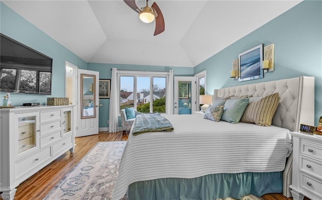 bedroom featuring vaulted ceiling, access to exterior, ceiling fan, and light hardwood / wood-style flooring