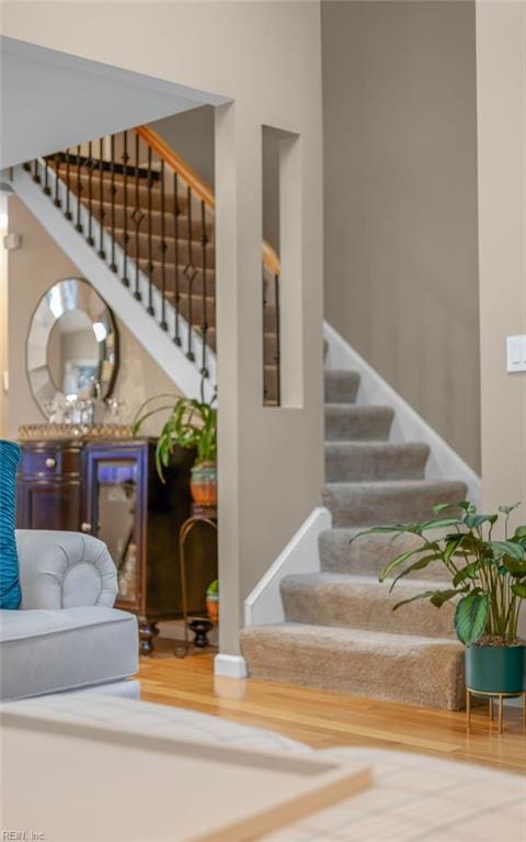 staircase with wood-type flooring