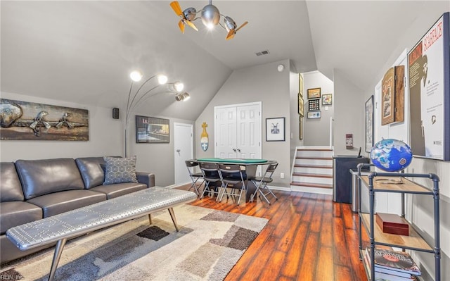 living room featuring vaulted ceiling and dark wood-type flooring