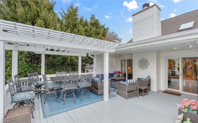 deck featuring a pergola and an outdoor hangout area