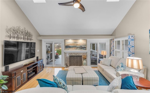 living room featuring lofted ceiling, wood-type flooring, and ceiling fan