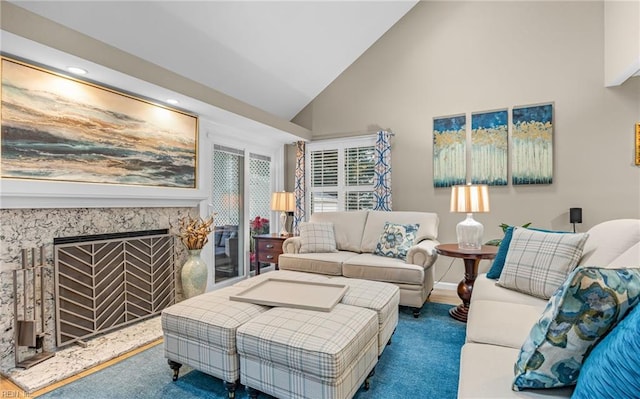 living room with a fireplace, high vaulted ceiling, and carpet