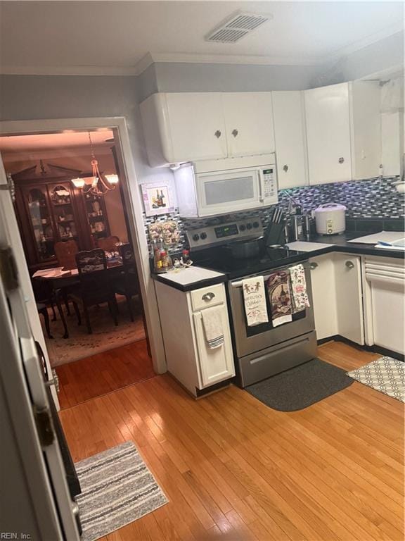 kitchen with white cabinetry, backsplash, stainless steel range with electric stovetop, crown molding, and light wood-type flooring