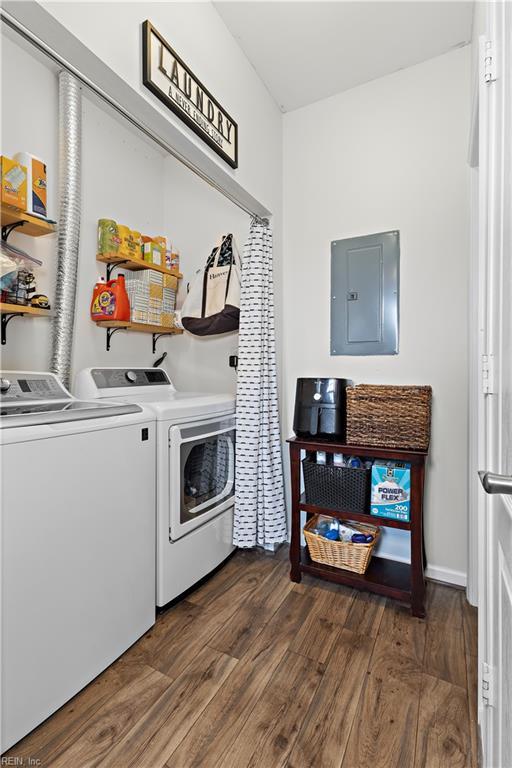 laundry room with dark hardwood / wood-style floors, electric panel, and independent washer and dryer