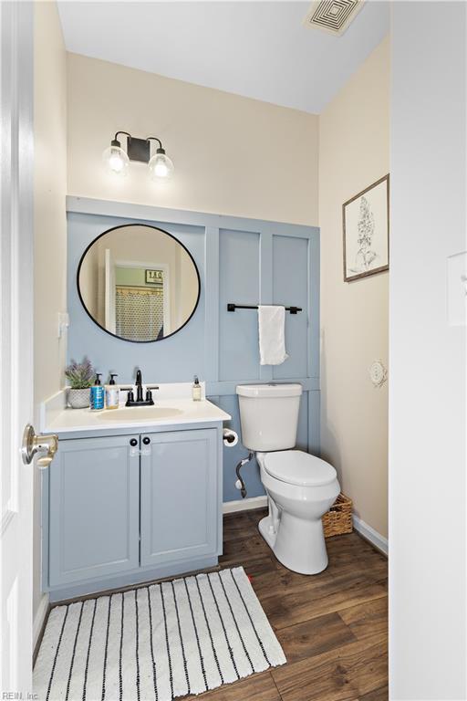 bathroom featuring vanity, hardwood / wood-style floors, and toilet