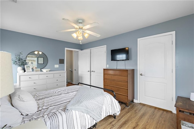 bedroom featuring ceiling fan, wood-type flooring, and a closet