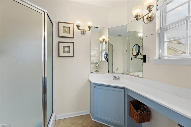 bathroom with vanity, a shower with door, and an inviting chandelier