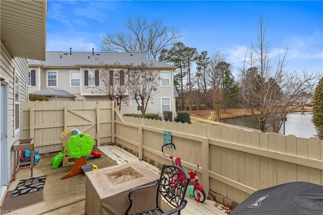 view of patio featuring a water view and an outdoor fire pit