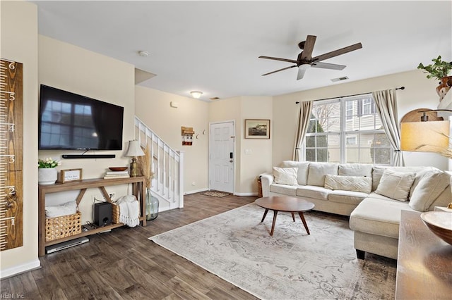 living room featuring dark hardwood / wood-style flooring and ceiling fan