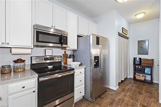 kitchen with appliances with stainless steel finishes, dark hardwood / wood-style floors, electric panel, and white cabinets