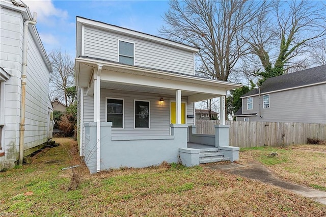 bungalow-style house featuring a front yard and covered porch