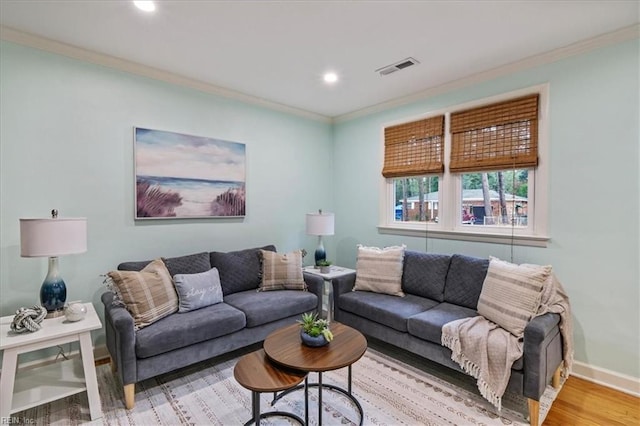 living room featuring crown molding and hardwood / wood-style floors