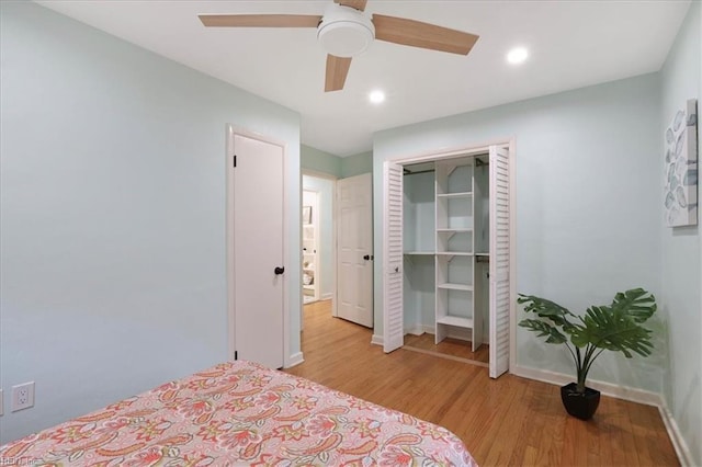 bedroom featuring light hardwood / wood-style flooring, a closet, and ceiling fan