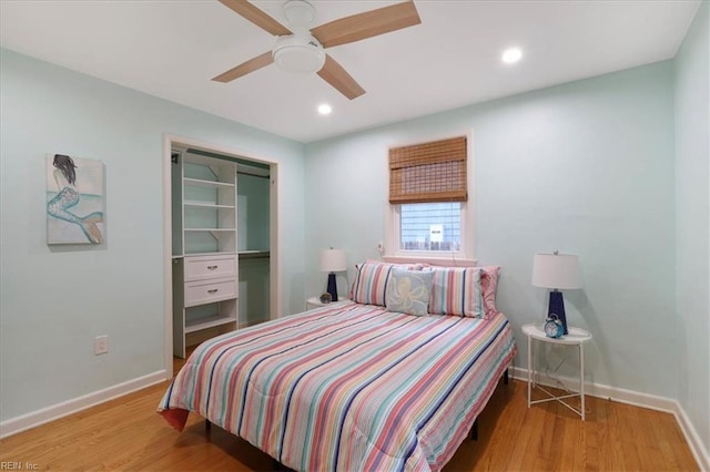 bedroom featuring hardwood / wood-style floors, a closet, and ceiling fan