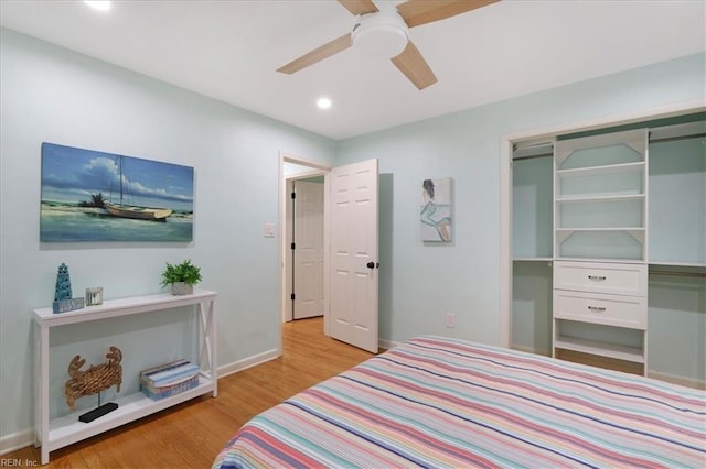 bedroom featuring ceiling fan, a closet, and light hardwood / wood-style flooring