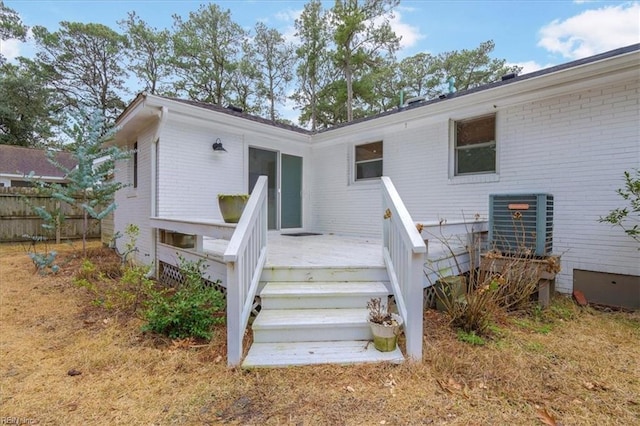 back of house with a wooden deck and central AC