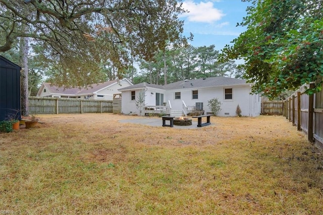 view of yard with a wooden deck, an outdoor fire pit, and a patio