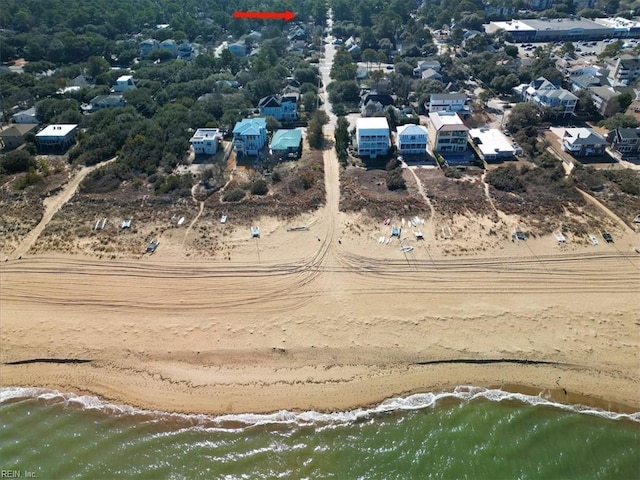 birds eye view of property featuring a water view and a view of the beach