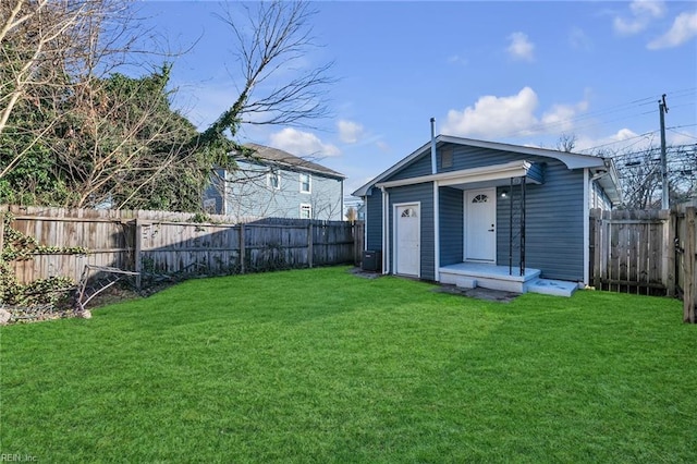 back of house with a yard and cooling unit