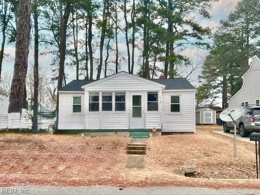 view of front of home featuring a storage unit