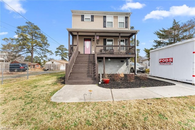 view of front of house with covered porch and a front lawn