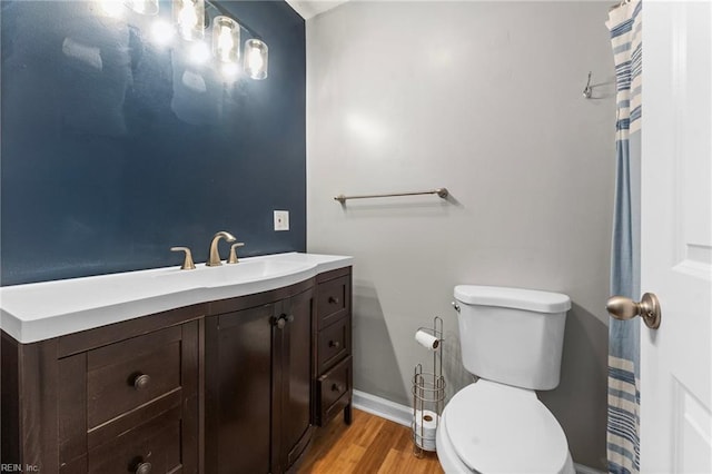 bathroom featuring vanity, hardwood / wood-style floors, and toilet