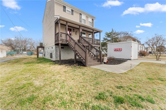 view of front of home with a porch and a front yard