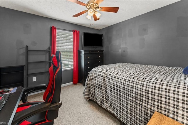 bedroom featuring a textured ceiling, ceiling fan, and carpet flooring