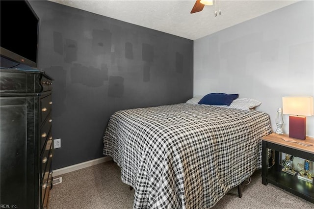 carpeted bedroom with a textured ceiling and ceiling fan