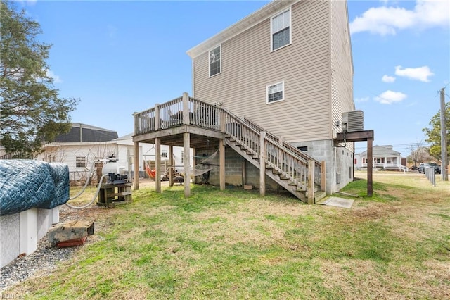 back of house featuring central AC, a lawn, and a deck